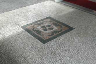 Mosaic picture tile with pebble mesh surround.