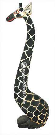 Wood carving of a Giraffe sitting.