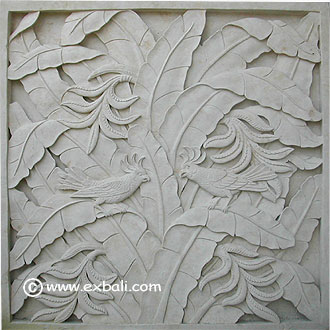 carved stone mural with birds